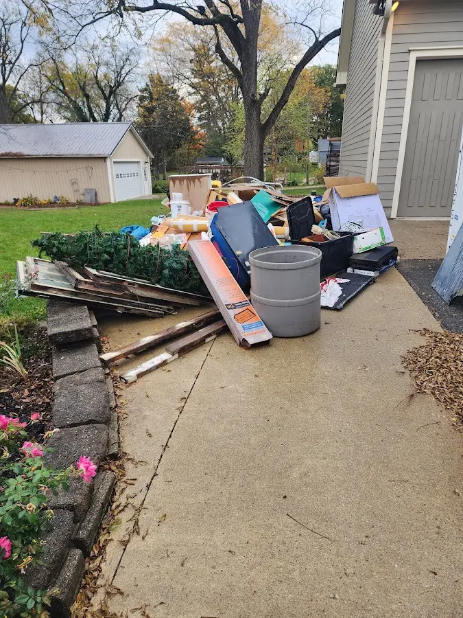 Dumpster being loaded with debris for 12 Yard Dumpster Rental in Bartlesville